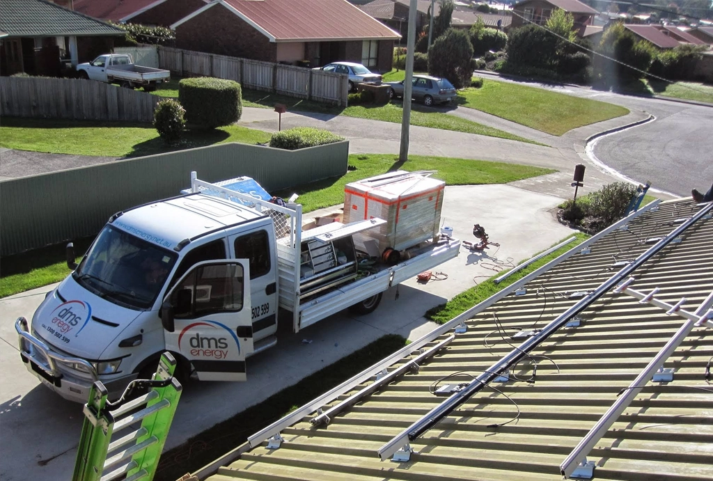 A DMS Energy truck loaded with solar panels on a job site