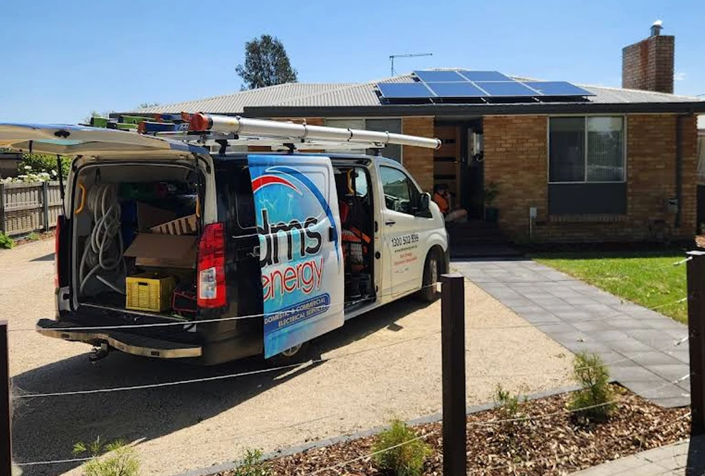 A branded DMS Energy service van parked at a customer&rsquo;s home